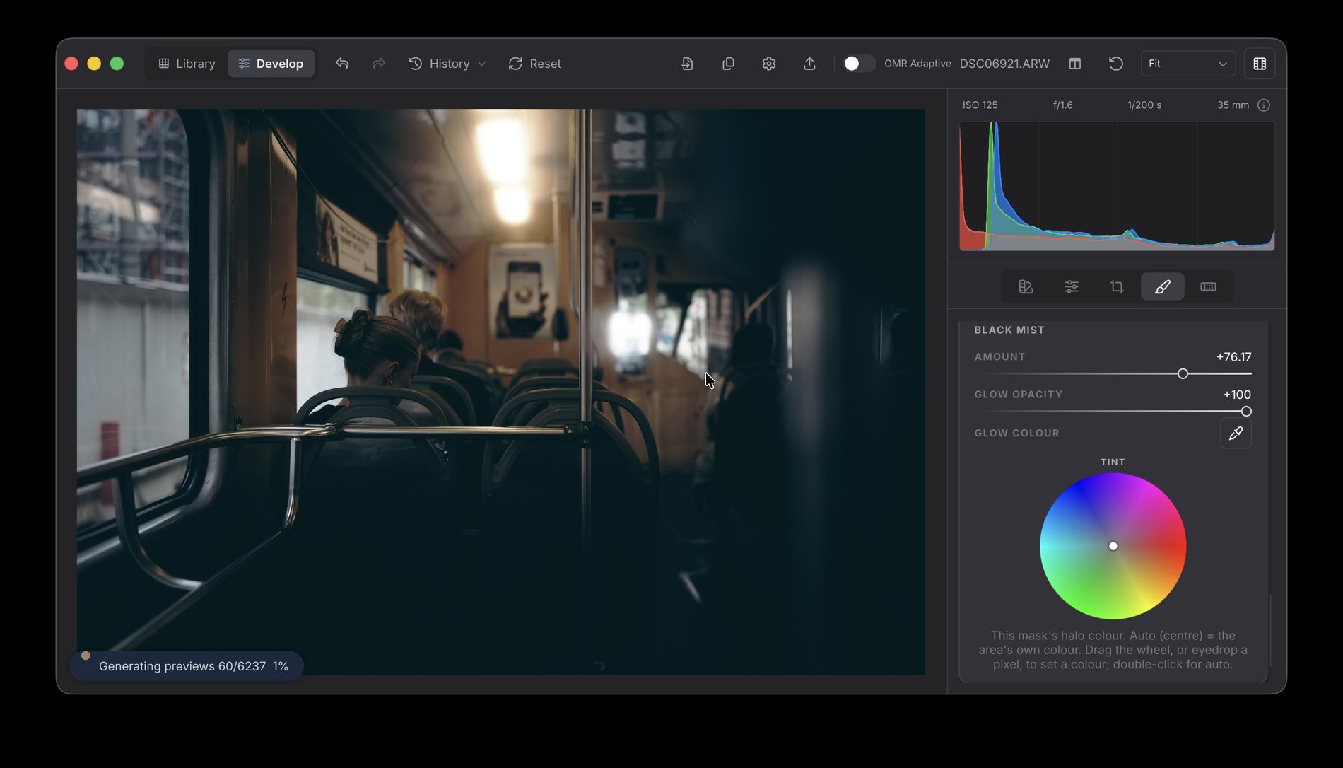 OhMyRAW developing a dim tram interior — the ceiling lamp blooms softly outward while the handrails stay sharp, with a mask's Black Mist amount, glow opacity and glow colour wheel open