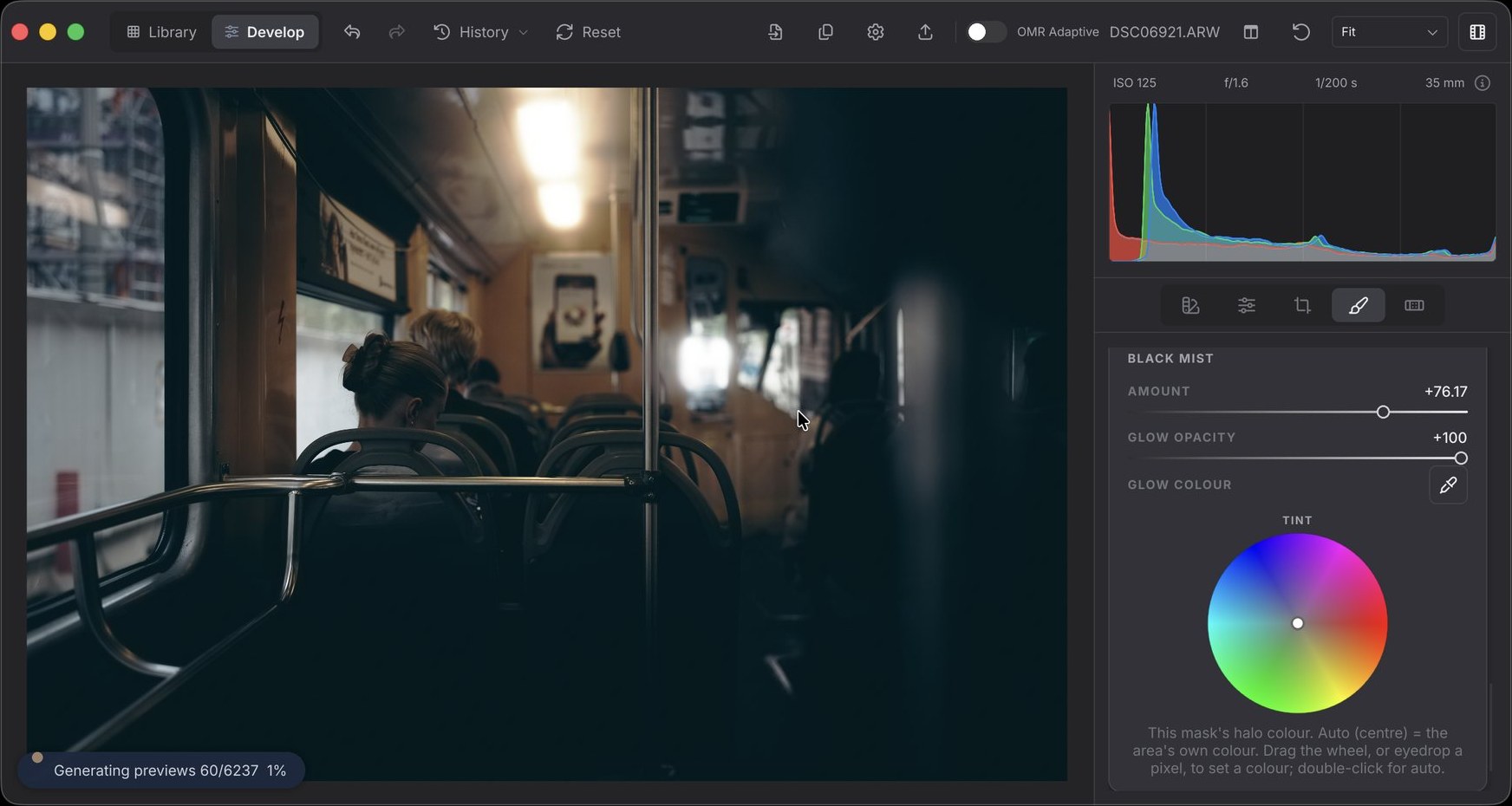OhMyRAW developing a dim tram interior — the ceiling lamp blooms softly outward while the handrails stay sharp, with a mask's Black Mist amount, glow opacity and glow colour wheel open